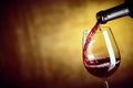 Pouring a single glass of red wine from a bottle Royalty Free Stock Photo