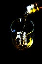 Pouring single malt whisky into a glass, golden color whisky