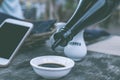 Pouring soy sauce in cafe. Smartphone wit black screen empty space on a background. Royalty Free Stock Photo