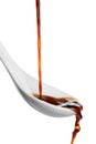 Pouring soy sauce into spoon against white Royalty Free Stock Photo