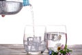 Pouring of sparkling soda mineral drink water in glasses with ic Royalty Free Stock Photo