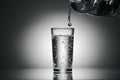 Pouring sparkling water in a glass on a dark background Royalty Free Stock Photo