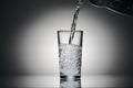 Pouring sparkling water in a glass on a dark background Royalty Free Stock Photo