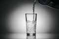 Pouring sparkling water in a glass on a dark background Royalty Free Stock Photo