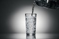 Pouring sparkling water in a glass on a dark background Royalty Free Stock Photo