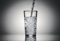 Pouring sparkling water in a glass on a dark background Royalty Free Stock Photo