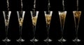 Pouring sparkling wine into a glass on a black background