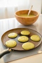 Pouring spinach pancake batter to frying pan Royalty Free Stock Photo