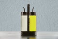 Glass flask bottle holder with pouring spout for storing vinegar and vegetable oil.