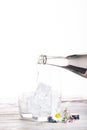 Pouring of stil mineral drink water in glasses with ice cubes cl Royalty Free Stock Photo