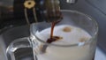 Pouring sweet caramel syrop for coffee. 4k