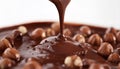 Pouring sweet chocolate onto hazelnuts against white background Royalty Free Stock Photo