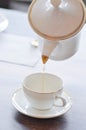 pouring tea , tea cup and tea pot or hot tea Royalty Free Stock Photo