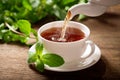 Pouring tea into a cup Royalty Free Stock Photo