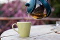 Pouring tea to a cup form teapot Royalty Free Stock Photo