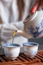 Pouring tea in traditional chinese teaware. Royalty Free Stock Photo