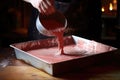 pouring the thickened mixture into a tray for cooling