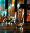 Pouring in tulip-shaped tasting glass Scotch single malt or blended whisky