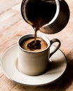 Pouring Turkish Coffee into the cup. Royalty Free Stock Photo