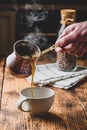 Pouring turkish coffee into white cup Royalty Free Stock Photo