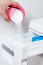 Pouring washing powder into the washing machine Royalty Free Stock Photo