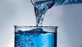 Pouring water from bottle into glass on grey background, closeup