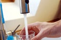 Pouring water into a glas. Royalty Free Stock Photo