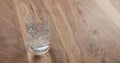 Pouring water in glass on wood table Royalty Free Stock Photo