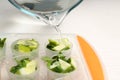 Pouring water into ice cube with lime slices and mint on table, closeup Royalty Free Stock Photo