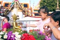 Pouring water over Buddha, Women pouring water over Buddha statues to signify cleansing for the New Year. Songkran festival Wat p