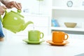 Pouring water from tea kettle to mug high key Royalty Free Stock Photo