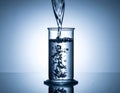 Pouring Water into a Test Tube with Bubbles and Splash Effect Royalty Free Stock Photo