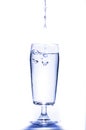 Pouring water to a glass on white background. Royalty Free Stock Photo