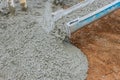 Pouring wet concrete while paving a driveway at construction site Royalty Free Stock Photo