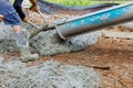 Pouring wet concrete while paving a driveway at construction site Royalty Free Stock Photo