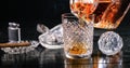 Pouring whiskey from a crystal decanter into a tumbler