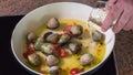 Pouring white wine while cooking spaghetti alle vongole clams Royalty Free Stock Photo