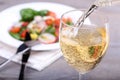 Pouring white wine into glass Royalty Free Stock Photo