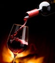 Pouring wine by the fireplace Royalty Free Stock Photo