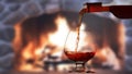 Pouring wine in front of the fireplace Royalty Free Stock Photo