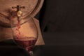 Pouring wine into a glass from an oak barrel, a panoramic close-up shot Royalty Free Stock Photo