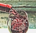 Pouring wine. Red wine in a glass. Sommelier wine into the glass on a blue background old. Royalty Free Stock Photo