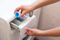 She pours the liquid powder in washing machine. Royalty Free Stock Photo