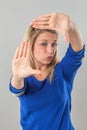 Pouting blond woman making a frame with her hands Royalty Free Stock Photo