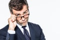 Pouting far-sighted elegant businessman moving eyeglasses down for disappointment Royalty Free Stock Photo