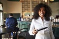 POV Close Up Of Waitress In Cocktail Bar Handing Customer Bill