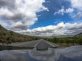 Pov driving a car on asphalt road in Andalusia.A power line cross the lane Royalty Free Stock Photo