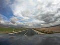 Pov driving a car on asphalt road in Andalusia.A power line cross the lane Royalty Free Stock Photo