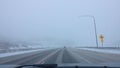 POV: Driving down an icy and snowy interstate freeway during an extreme blizzard