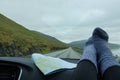 POV: Driving down scenic coastal road with your feet resting on the dashboard. Royalty Free Stock Photo